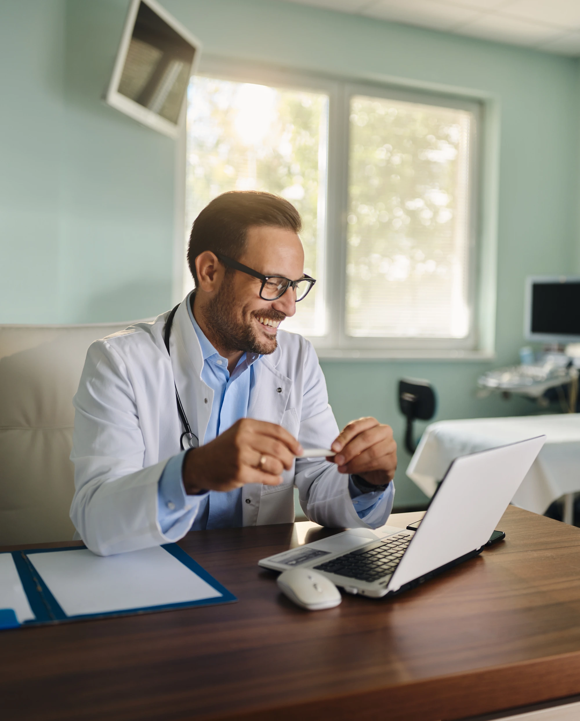 Medical professional using laptop at desk