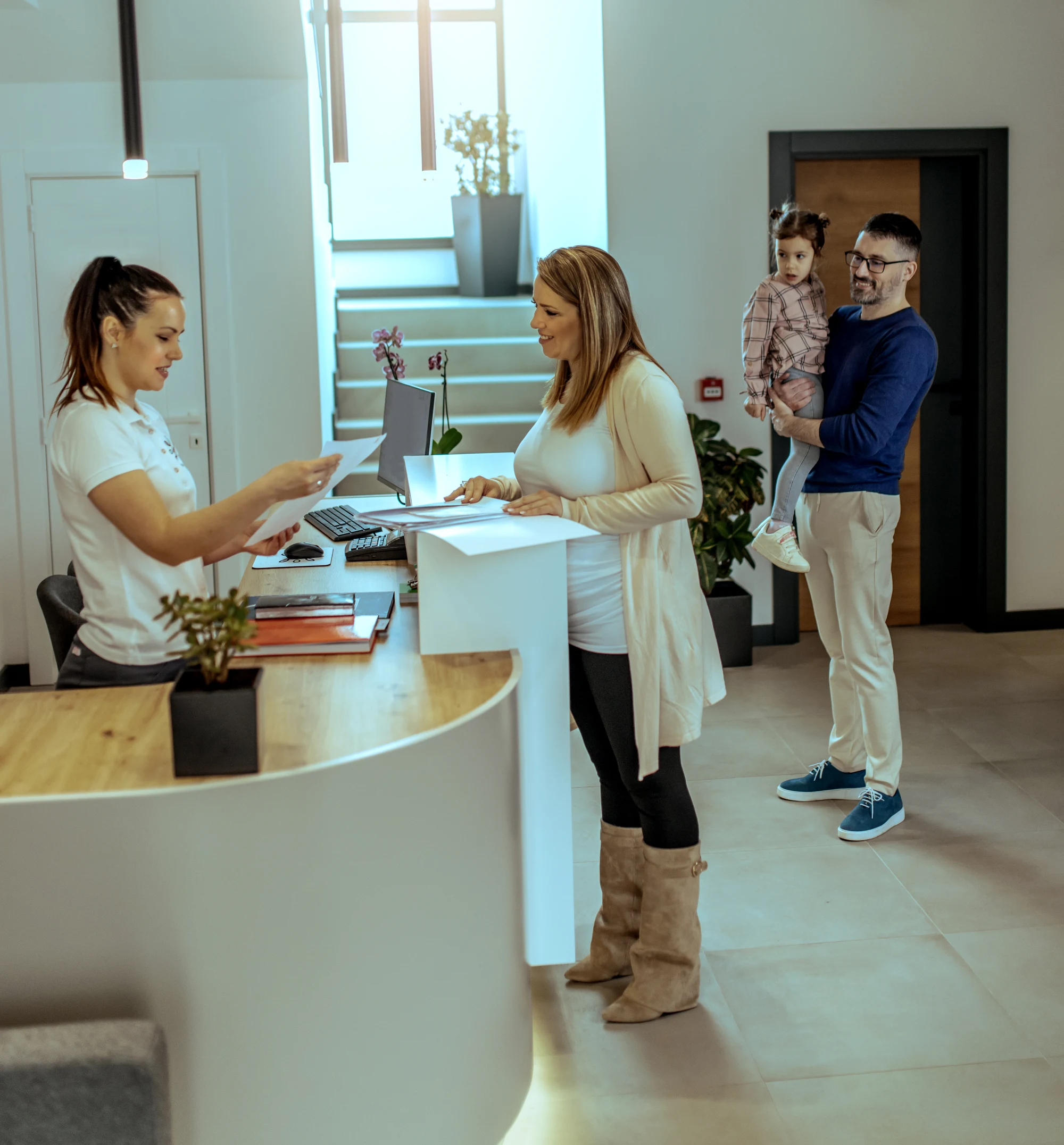 Woman checking in at reception desk