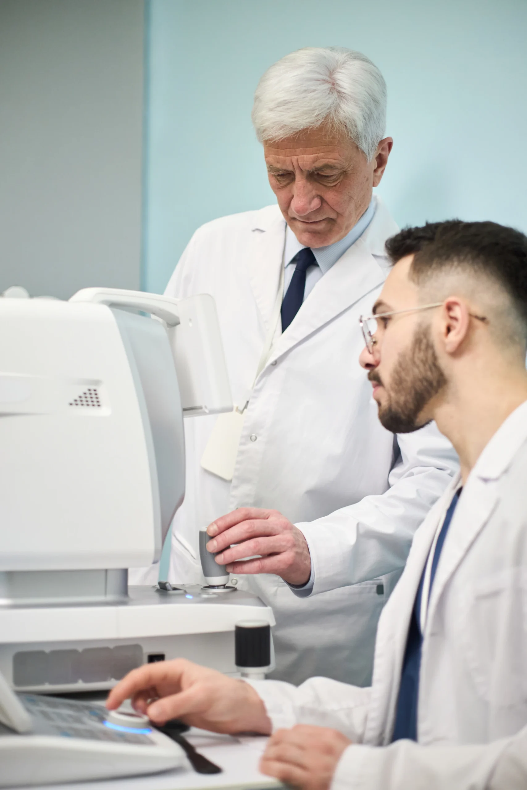 Eye specialists examining patient data