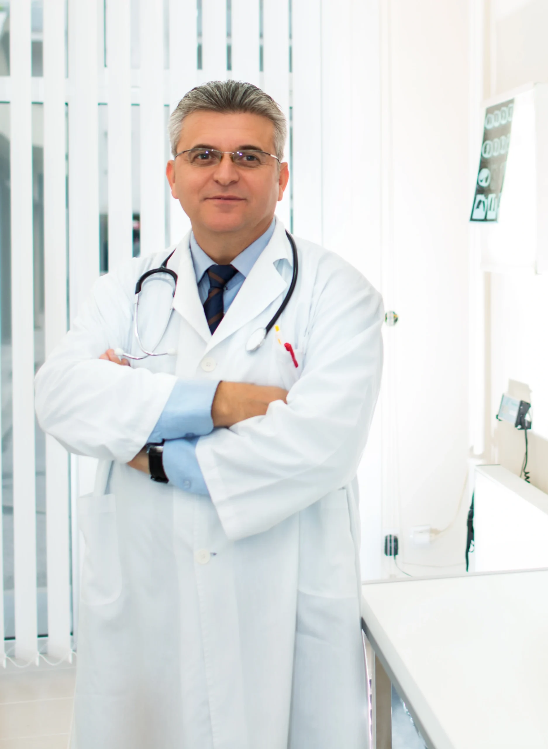 Confident doctor standing with folded arms