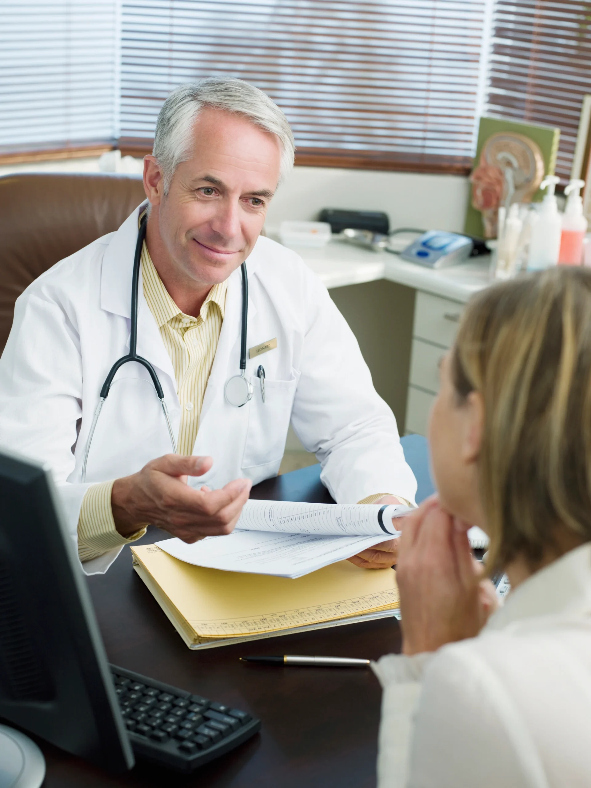 Doctor consulting with a patient in office.