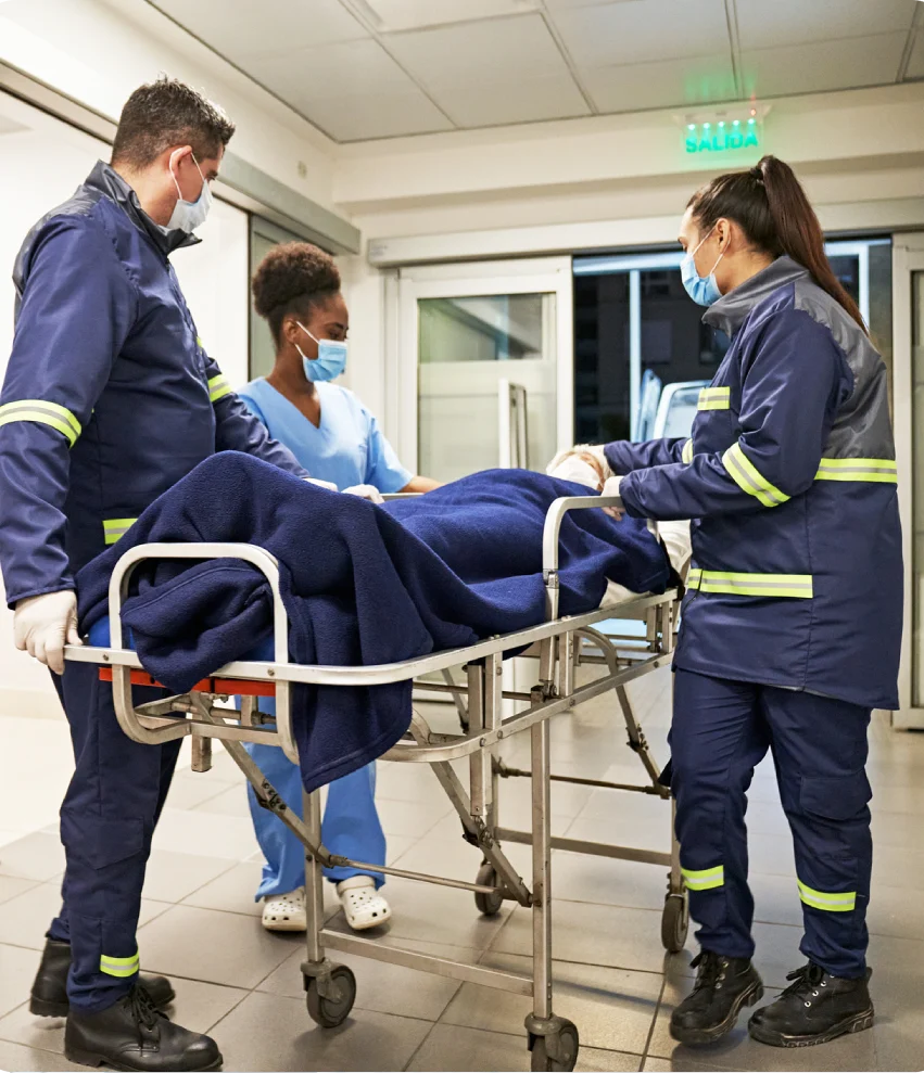 Medical team transporting patient in corridor
