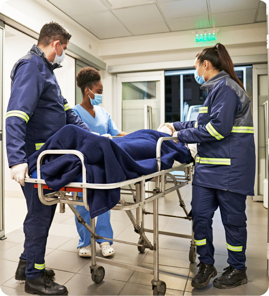 Medical team transporting patient in corridor